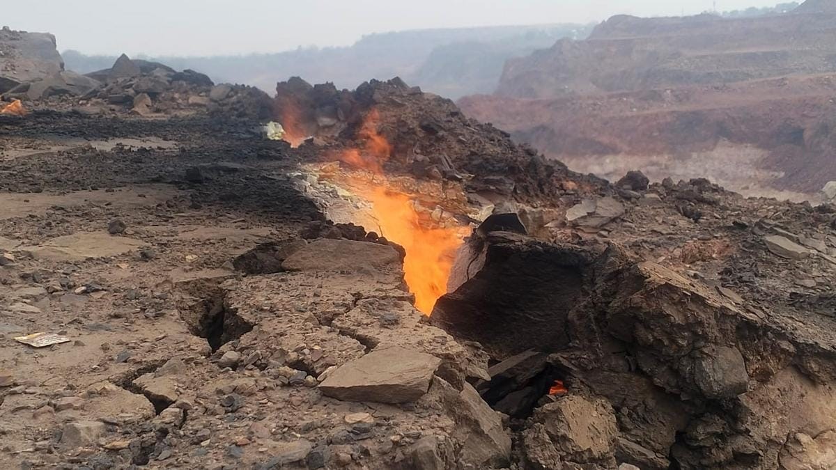 Jharia Coal Fire Dhanbad — smoke vents and ground cracks above underground coal seam fire, Jharkhand